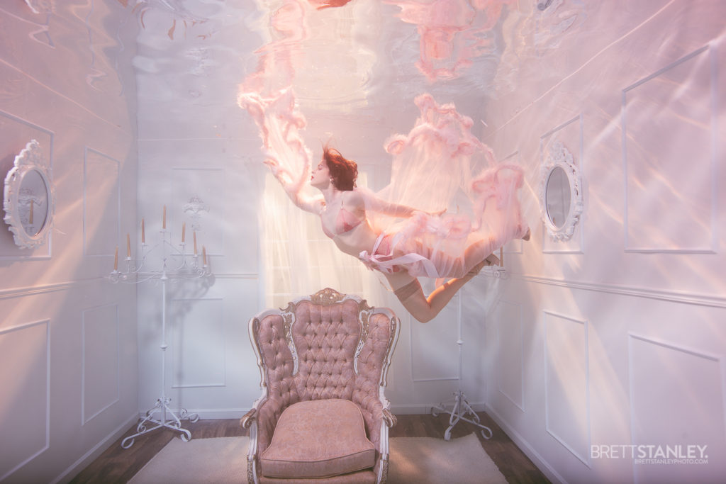 Underwater room or set showing a model posing for underwater photography